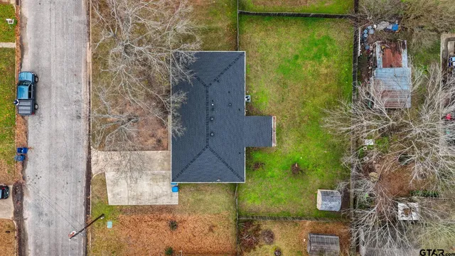 an aerial view of a house with a yard
