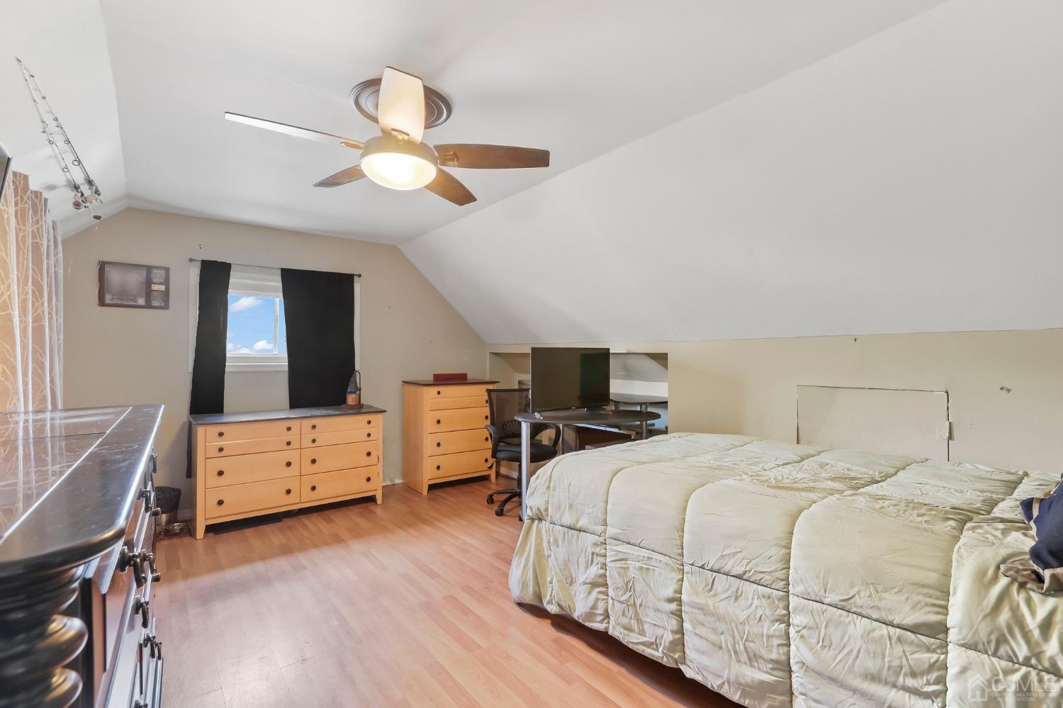 26 Sunrise Road Old Bridge, NJ 08857 - Photo 24 of 33 a bedroom with a bed and a chandelier