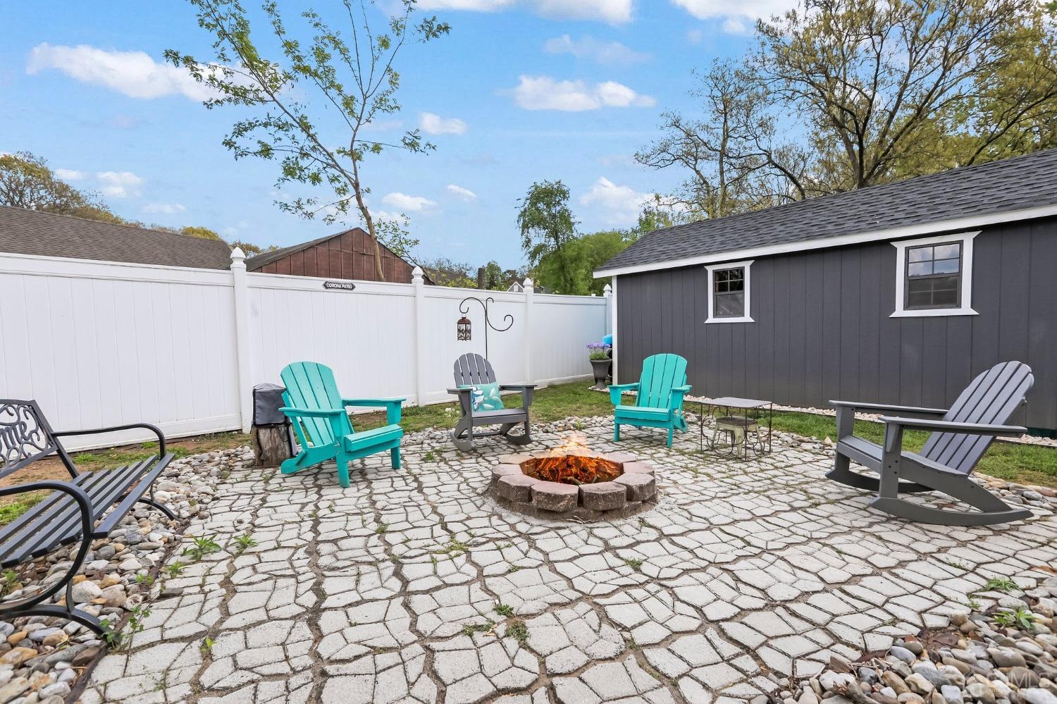 26 Sunrise Road Old Bridge, NJ 08857 - Photo 29 of 33 a backyard of a house with fire pit and outdoor seating
