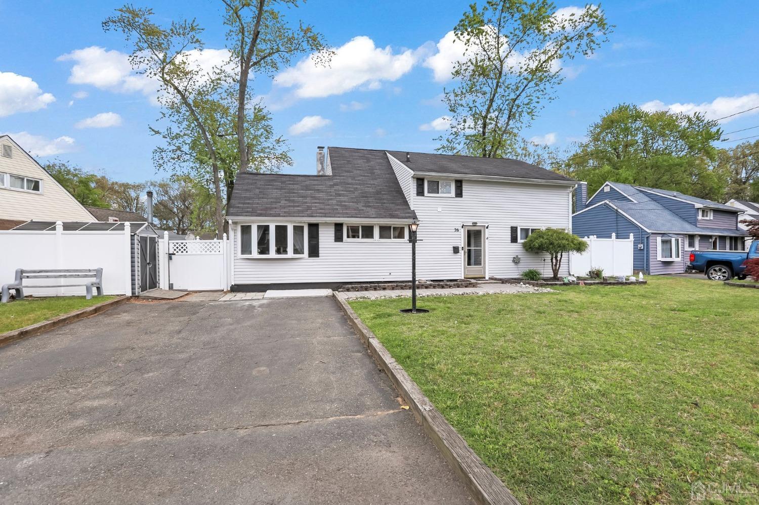 26 Sunrise Road Old Bridge, NJ 08857 - Photo 4 of 33 a front view of a house with a garden and yard