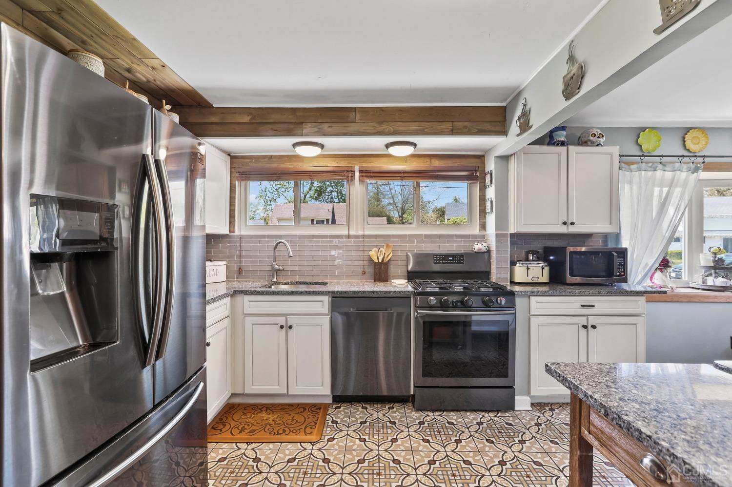 26 Sunrise Road Old Bridge, NJ 08857 - Photo 6 of 33 a kitchen with stainless steel appliances granite countertop a stove and a refrigerator
