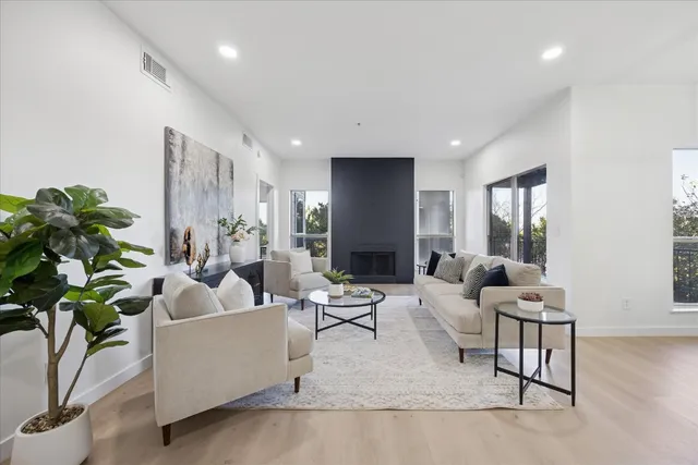 a living room with furniture and a potted plant