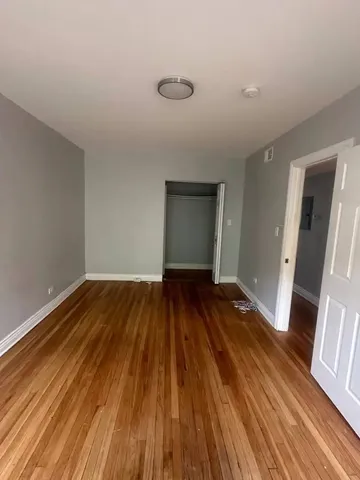 a view of a room with wooden floor and staircase