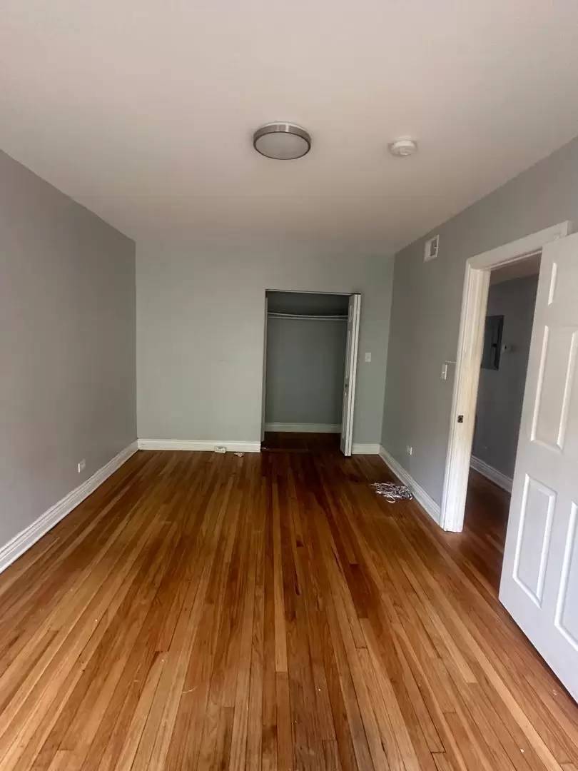 8319 South Drexel Avenue, Unit 3 Chicago, IL 60619 - Photo 3 of 3 a view of a room with wooden floor and staircase