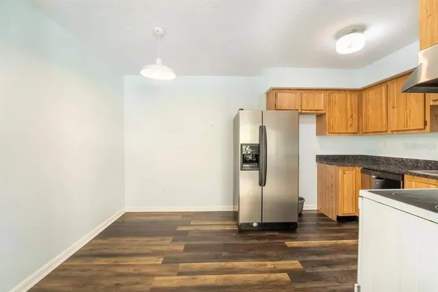 a kitchen with refrigerator and window