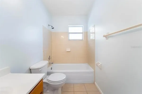 a bathroom with a toilet a sink and bathtub