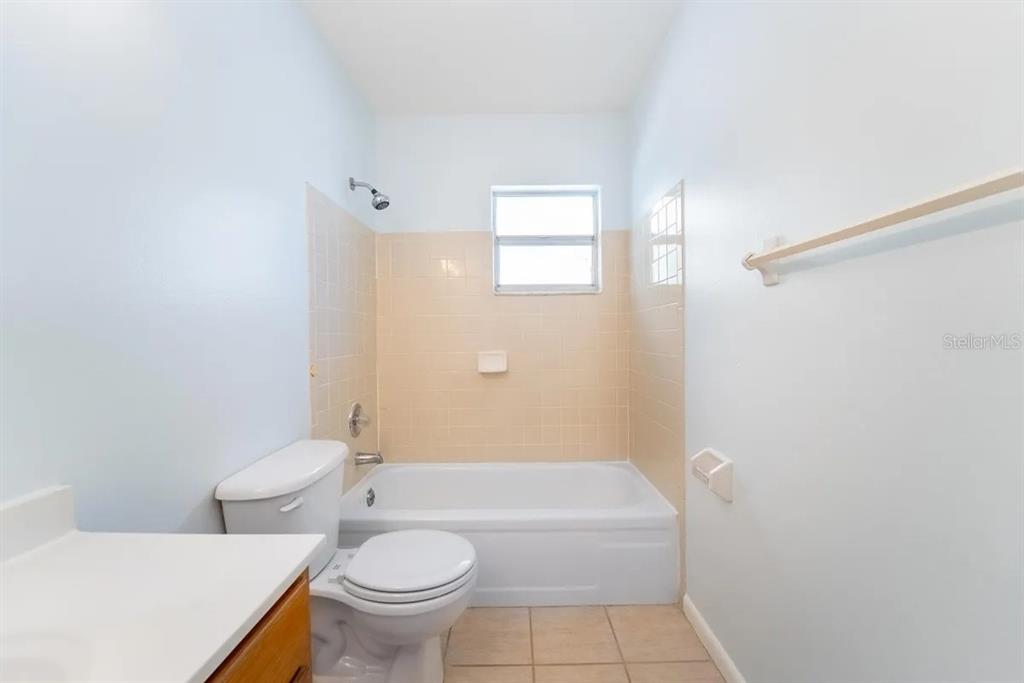 1021 Apollo Beach Boulevard, Unit 6 Apollo Beach, FL 33572 - Photo 8 of 18 a bathroom with a toilet a sink and bathtub