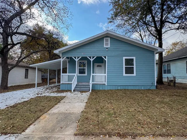 a house that has a tree in front of a house