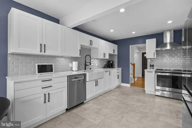 a kitchen with white cabinets and white appliances
