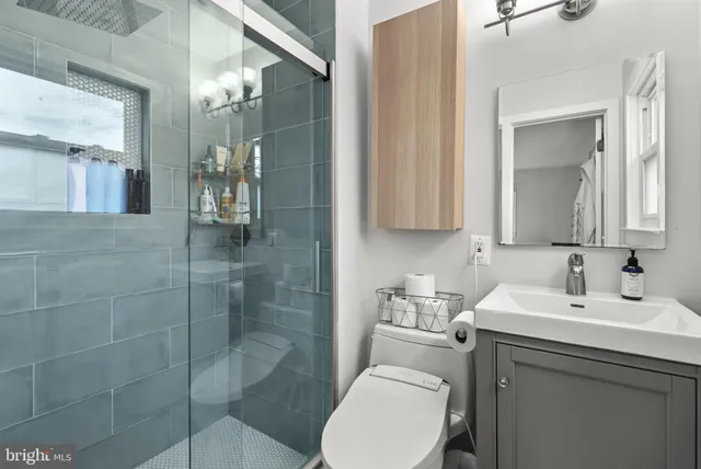 a bathroom with a toilet sink and shower
