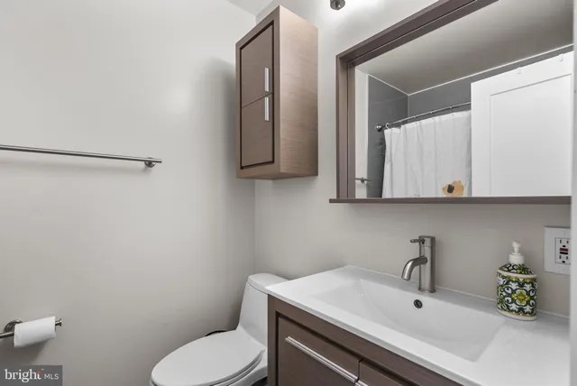 a bathroom with a sink toilet and vanity