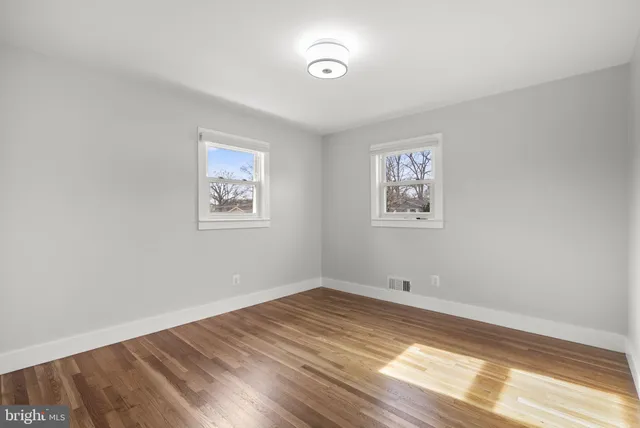 a view of room with window and wooden floor