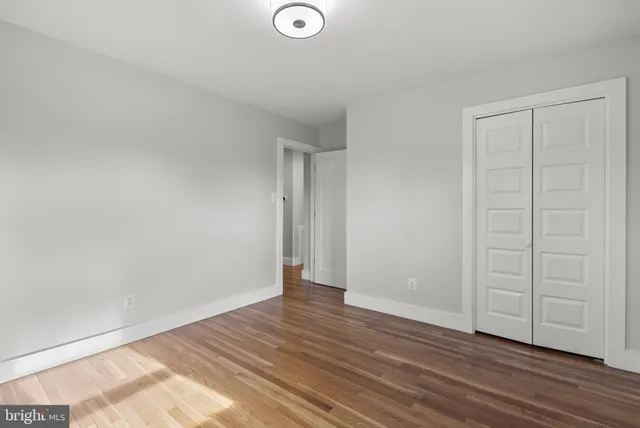 a view of an empty room and wooden floor