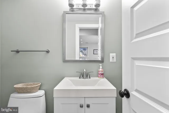 a bathroom with a sink toilet and mirror