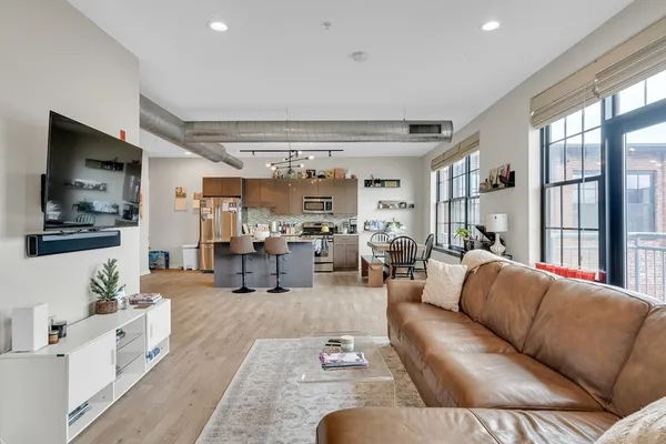 a living room with furniture large window and flat screen tv