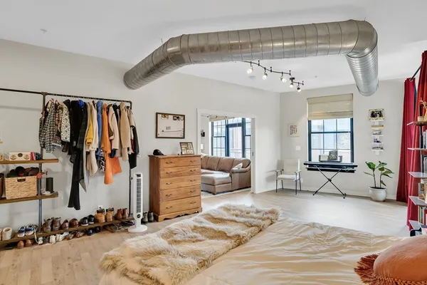 a bedroom with furniture and a walk in closet