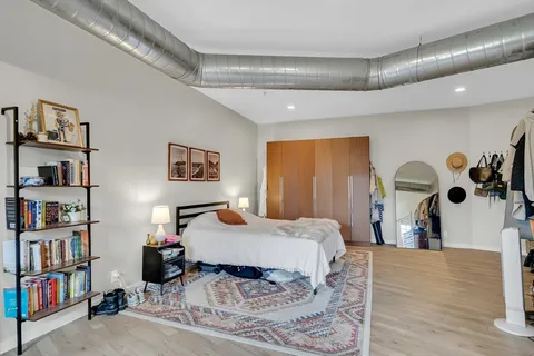a bedroom with a bed and a book shelf