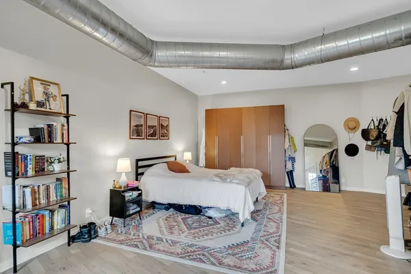 a bedroom with a bed and a book shelf