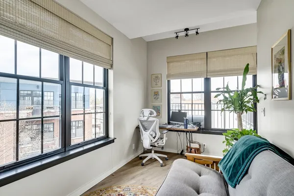 a living room with furniture and floor to ceiling windows