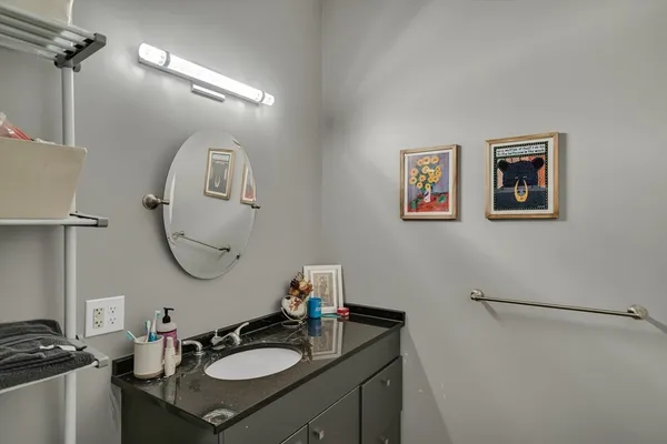 a bathroom with a sink mirror and a toilet