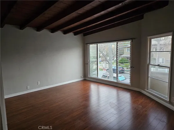 a view of room with window and wooden floor