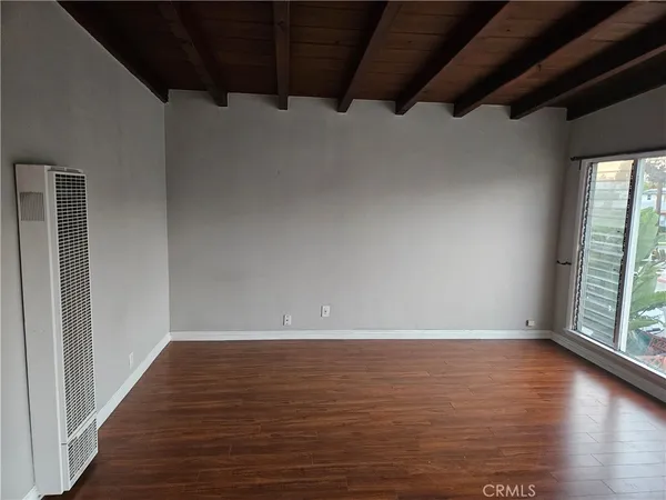 a view of room with window and hardwood floor