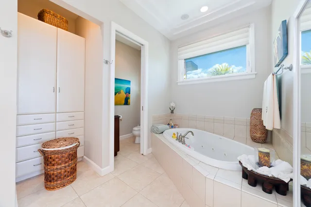 a bathroom with a bathtub sink and mirror