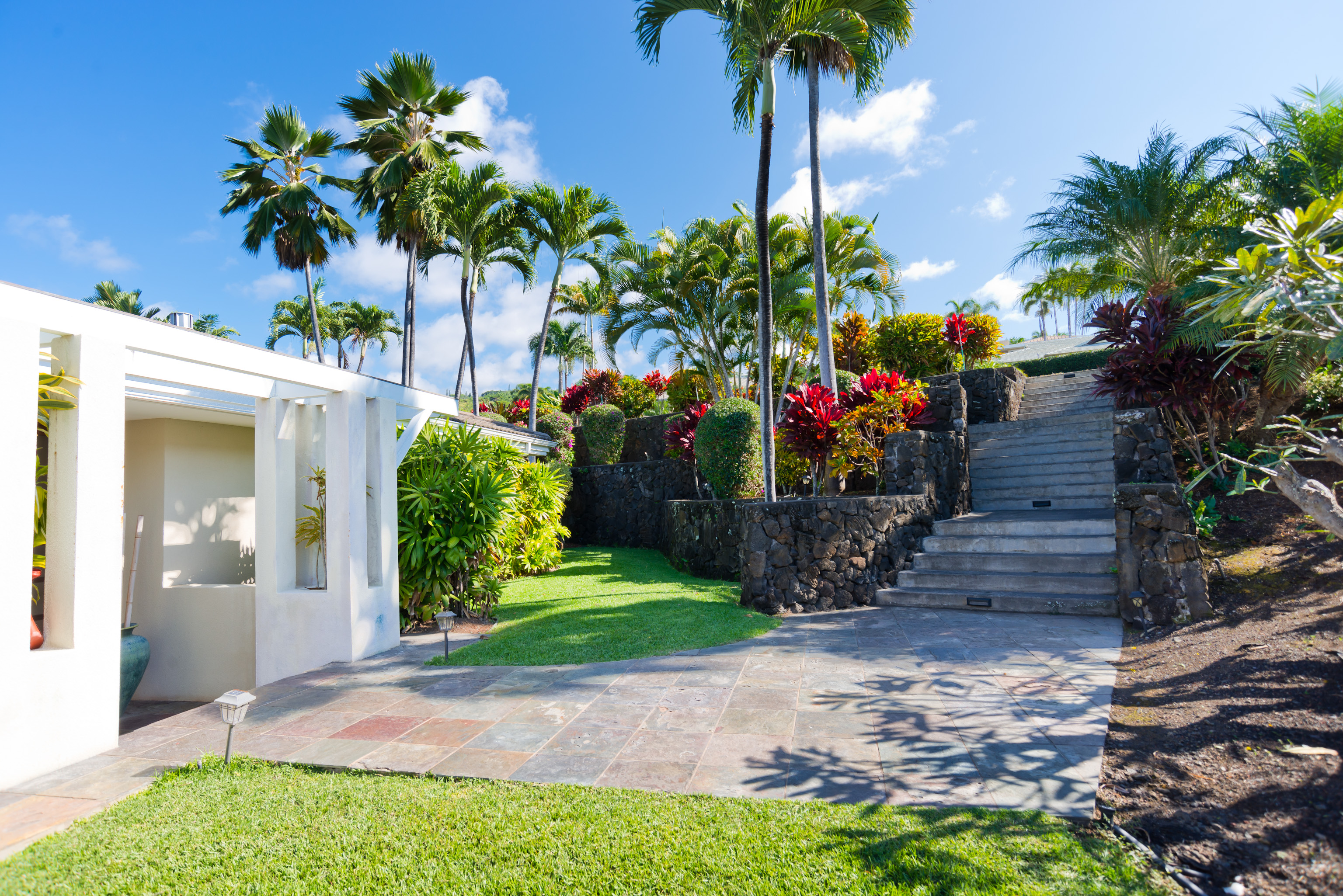 78-7018 Mololani Street Kailua-Kona, HI 96740 - Photo 26 of 30 a front view of a house with a yard and a garage