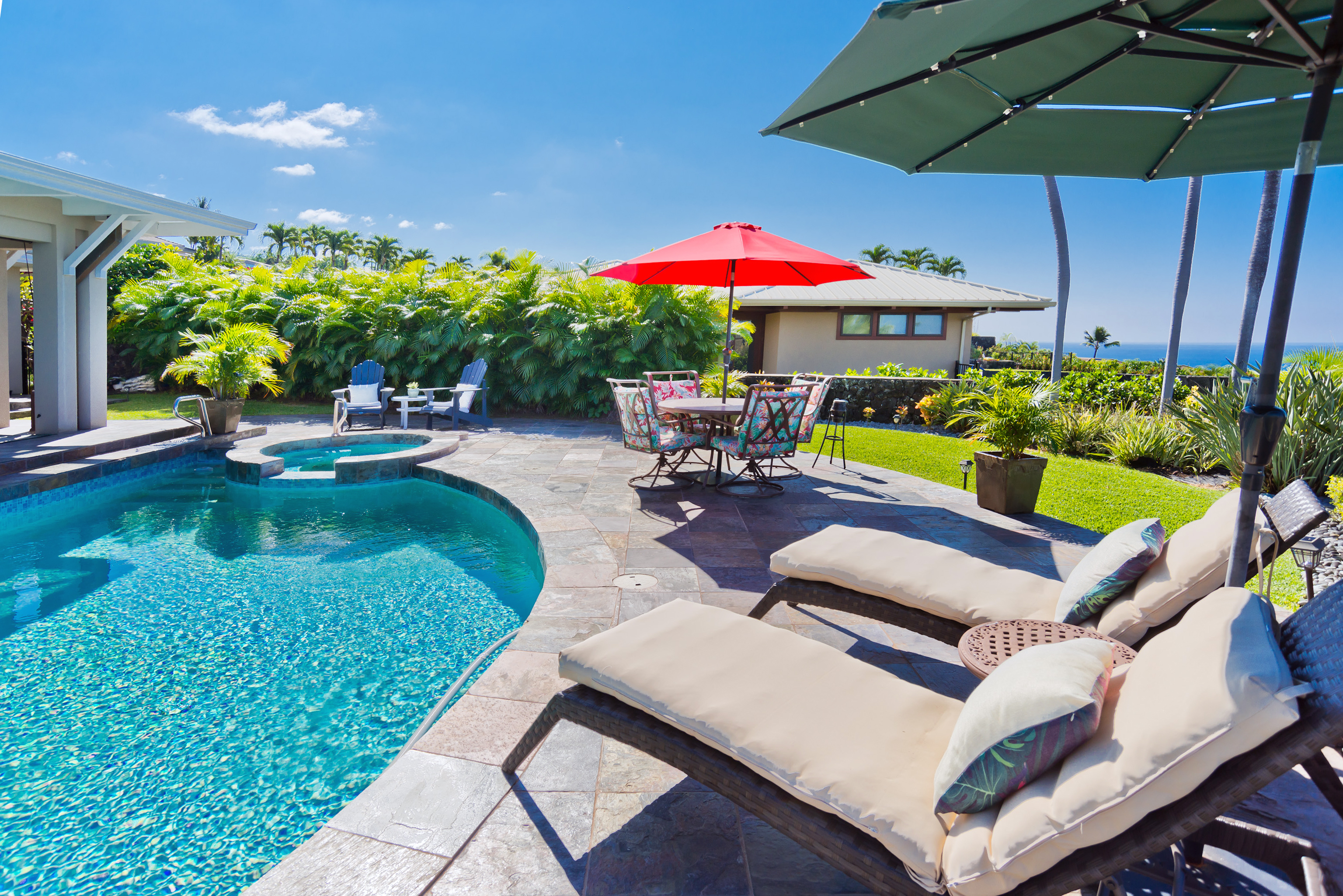 78-7018 Mololani Street Kailua-Kona, HI 96740 - Photo 29 of 30 a view of a patio with a table and chairs under an umbrella