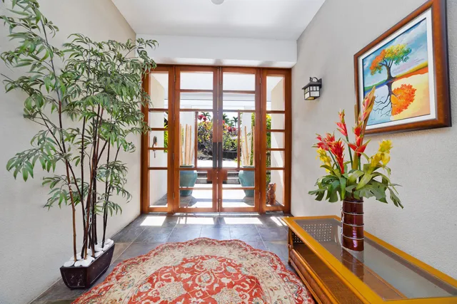 a living room filled with furniture and a potted plant