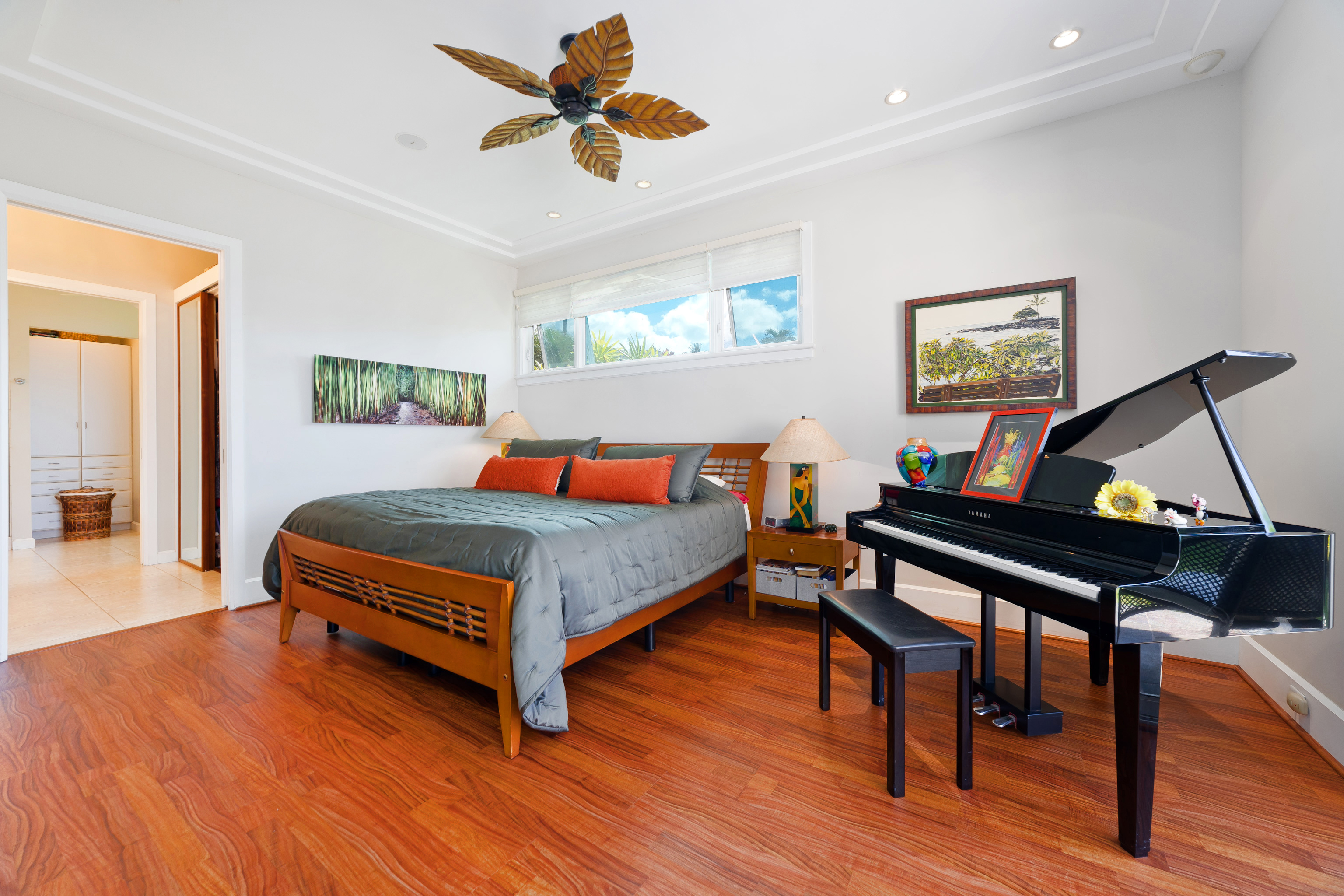 78-7018 Mololani Street Kailua-Kona, HI 96740 - Photo 8 of 30 a bedroom with a bed a dresser and wooden floor