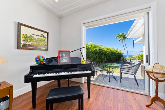 a view of a workspace with furniture and wooden floor