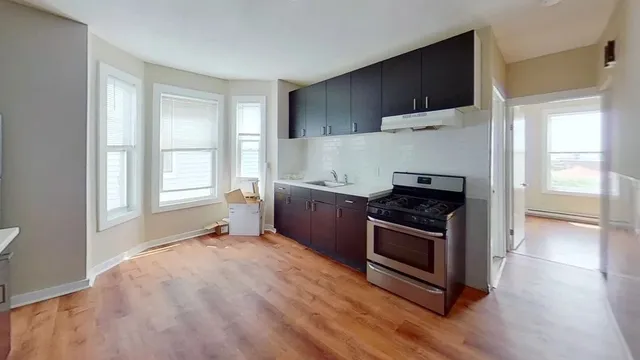 a kitchen with a stove a sink and a refrigerator