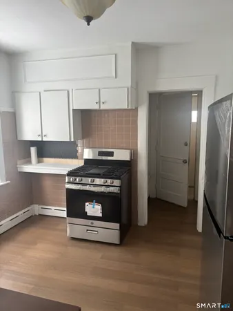 a kitchen with stainless steel appliances granite countertop a stove and a refrigerator
