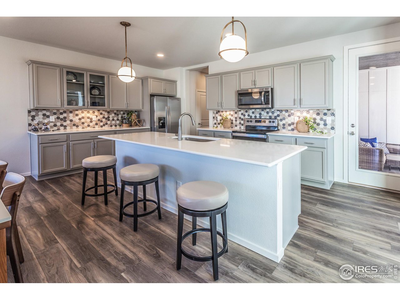 6101 Sublette Road Timnath, CO 80547 - Photo 12 of 34 a kitchen with stainless steel appliances a dining table chairs and sink