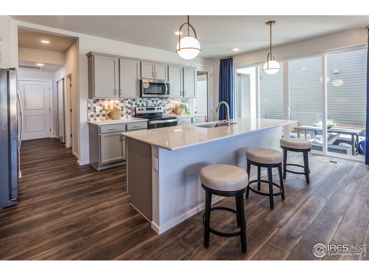 6101 Sublette Road Timnath, CO 80547 - Photo 13 of 34 a kitchen with sink cabinets and dining table