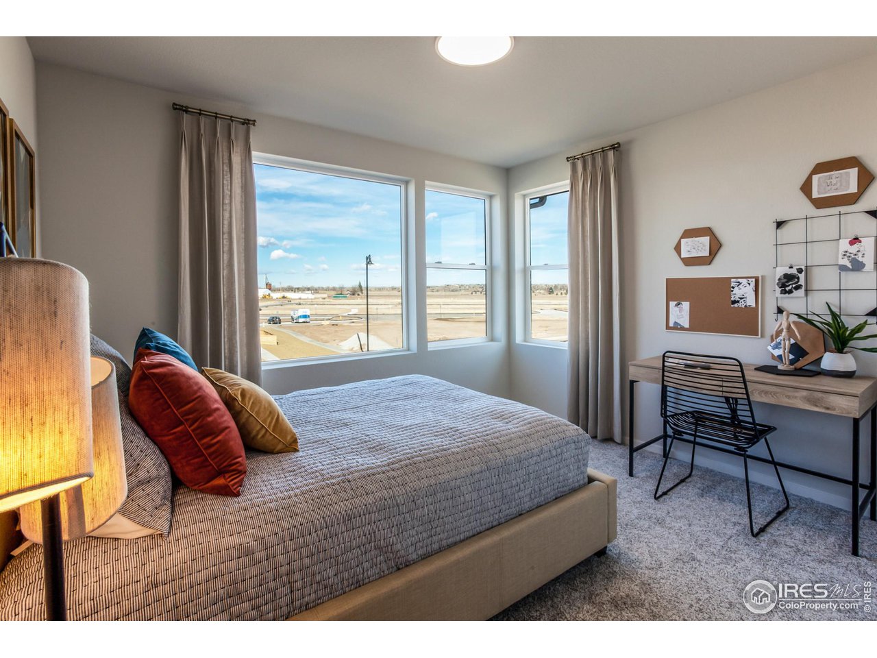 6101 Sublette Road Timnath, CO 80547 - Photo 24 of 34 a bedroom with a bed a chair and next to a window