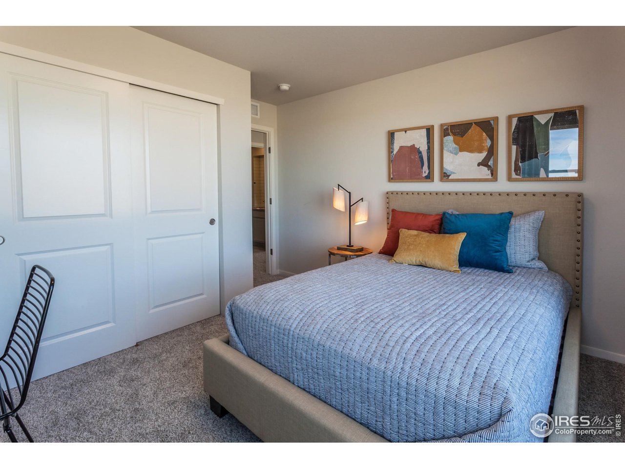 6101 Sublette Road Timnath, CO 80547 - Photo 26 of 34 a bedroom with a bed and painting on the wall