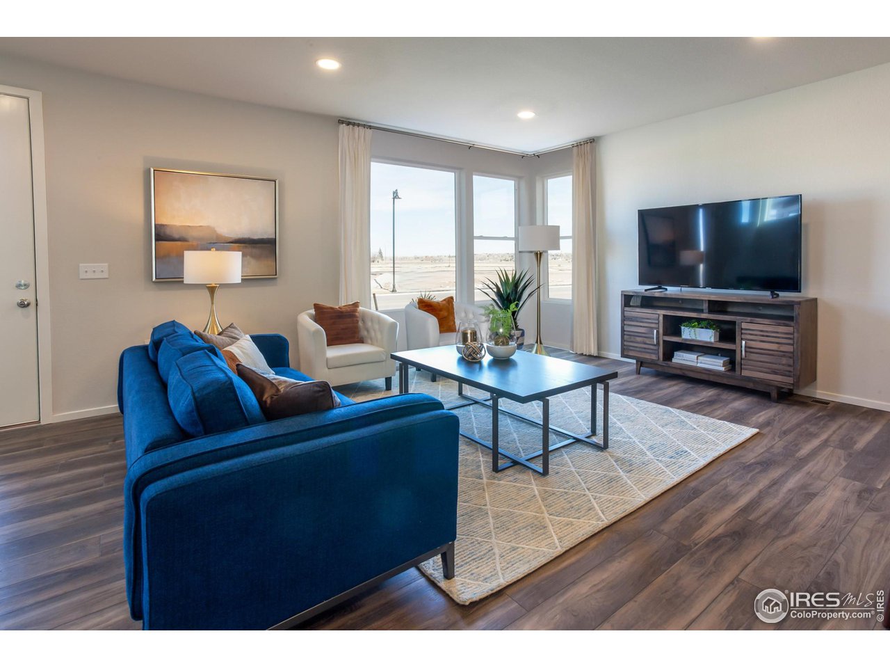 6101 Sublette Road Timnath, CO 80547 - Photo 5 of 34 a living room with furniture and a flat screen tv