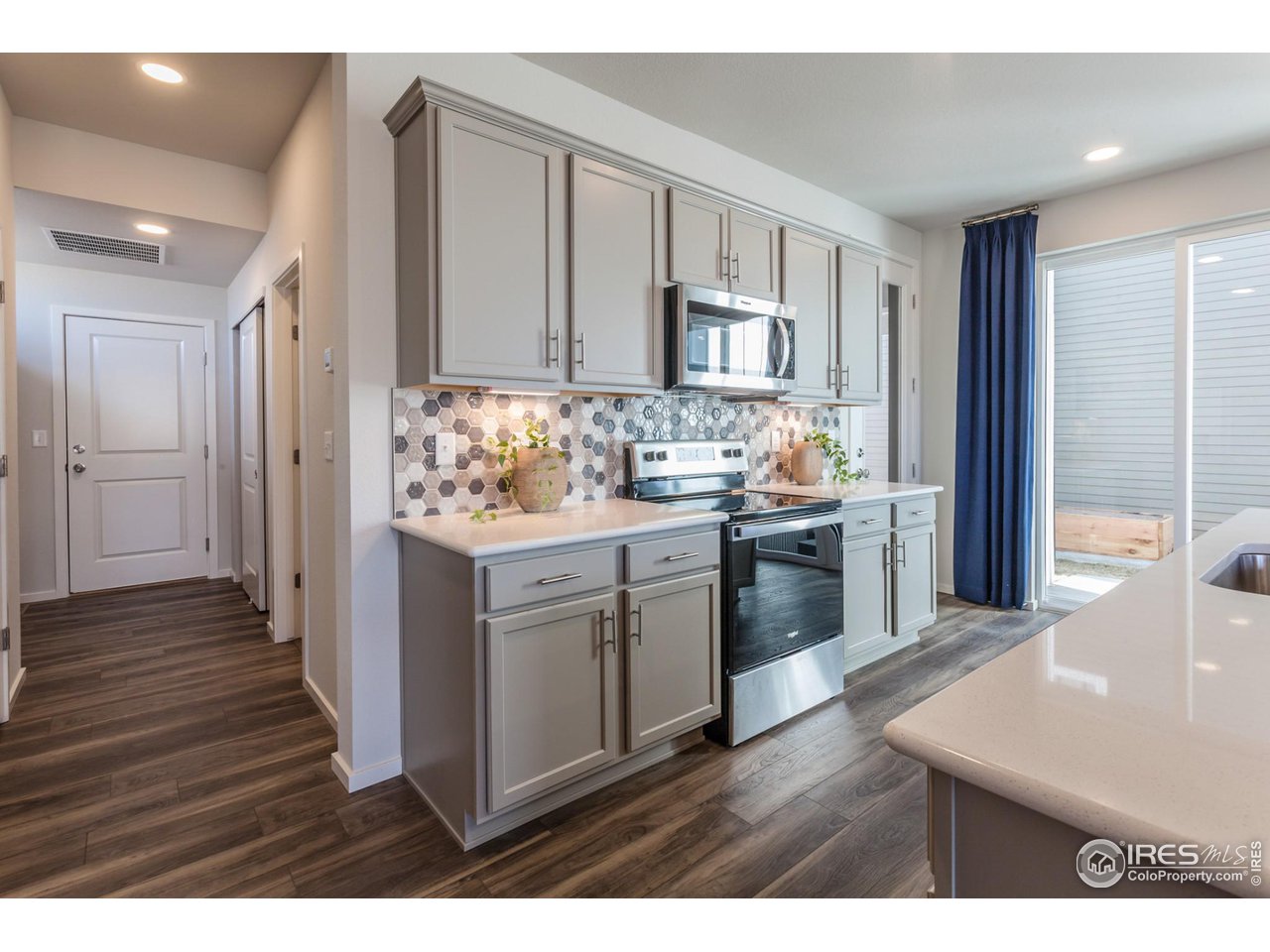 6101 Sublette Road Timnath, CO 80547 - Photo 9 of 34 a kitchen with stainless steel appliances a stove a sink and a refrigerator