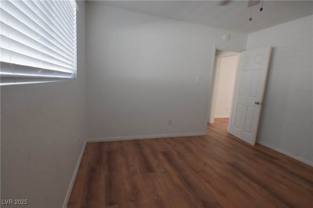 2608 East Mesquite Avenue, Unit 3 Las Vegas, NV 89101 - Photo 14 of 16 Empty room featuring dark wood finished floors and ceiling fan