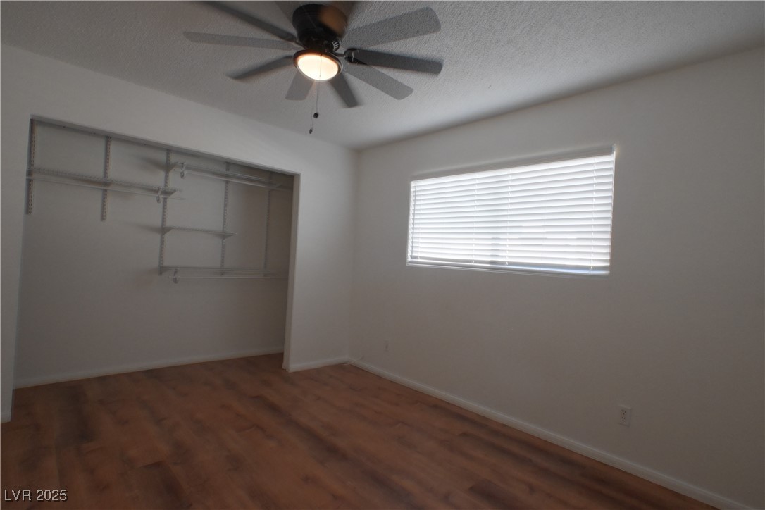 2608 East Mesquite Avenue, Unit 3 Las Vegas, NV 89101 - Photo 15 of 16 Unfurnished bedroom with a textured ceiling, wood finished floors, a closet, and a ceiling fan