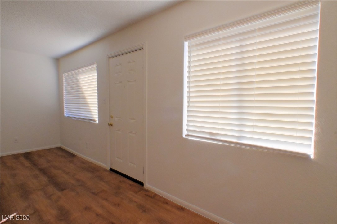 2608 East Mesquite Avenue, Unit 3 Las Vegas, NV 89101 - Photo 4 of 16 Empty room featuring dark wood-style flooring and baseboards