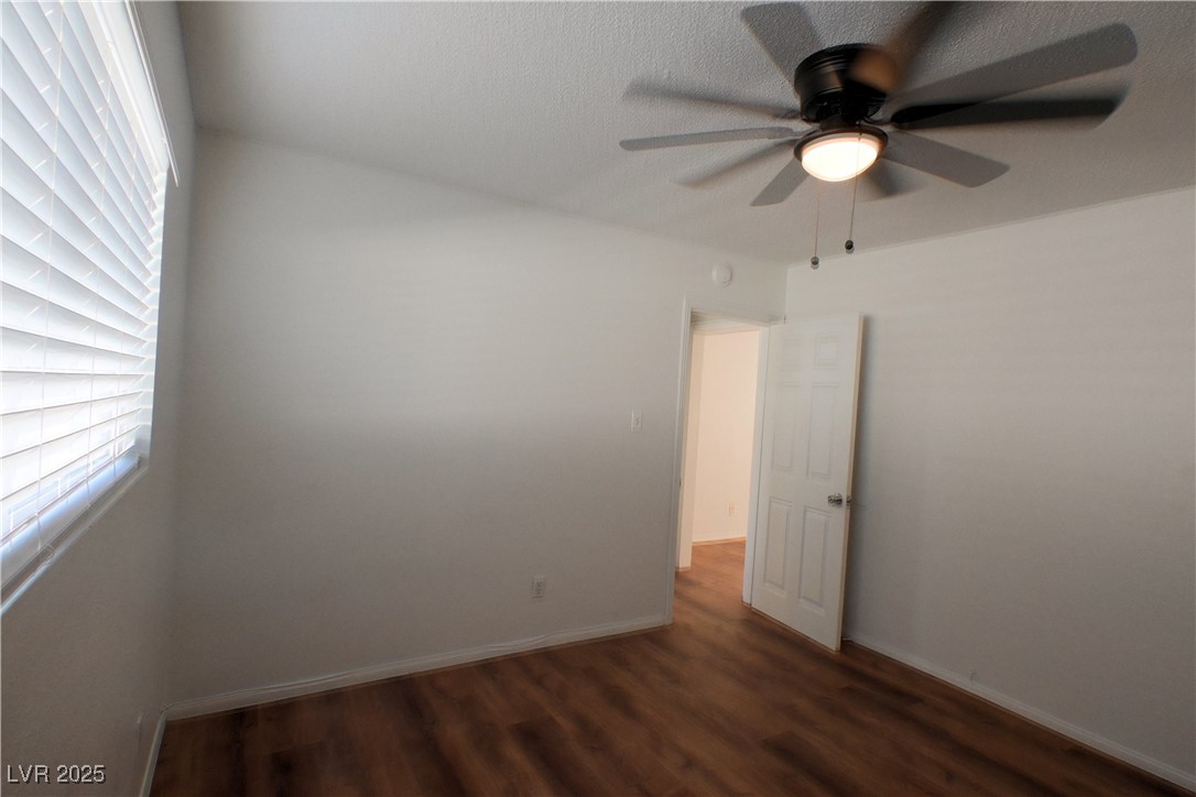 2608 East Mesquite Avenue, Unit 3 Las Vegas, NV 89101 - Photo 9 of 16 Empty room featuring dark wood finished floors and ceiling fan
