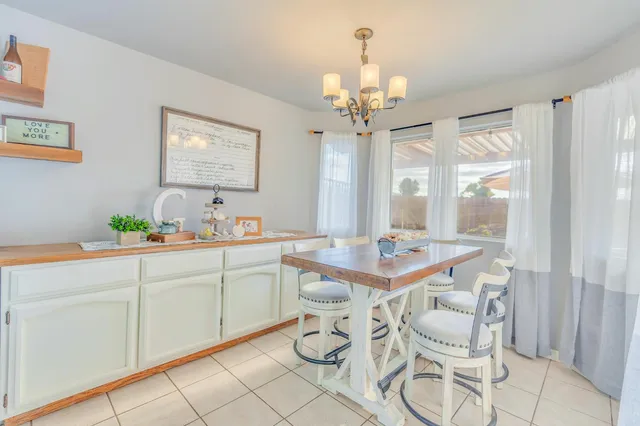 a bed sitting in a bedroom next to a book shelf