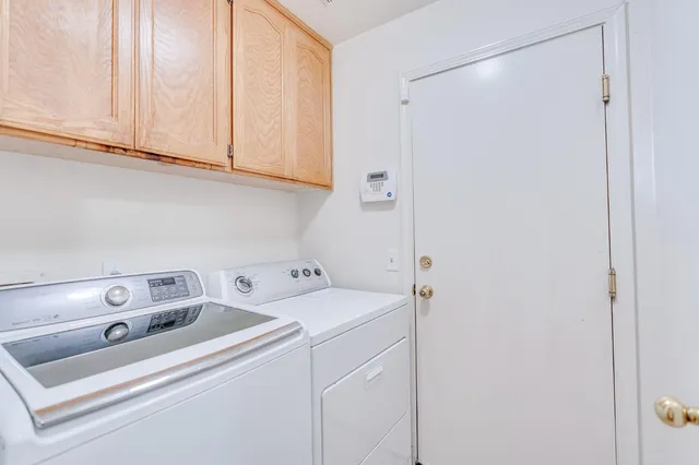 a view of a patio with a table and chairs under an umbrella