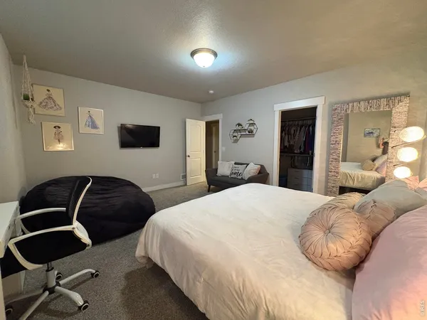 a bedroom with a bed and a chair