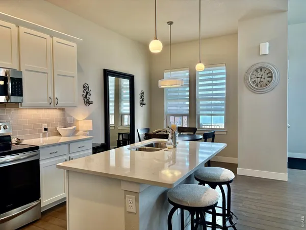 a kitchen with sink refrigerator and cabinets