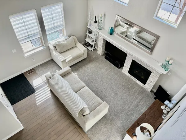 a living room with furniture fireplace and flat screen tv