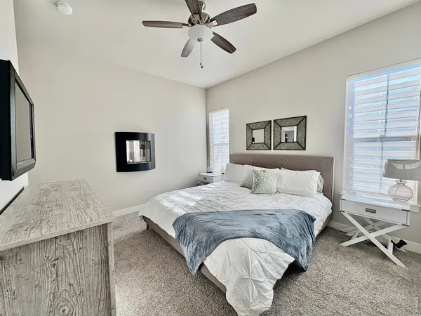 a bedroom with a bed and a chandelier
